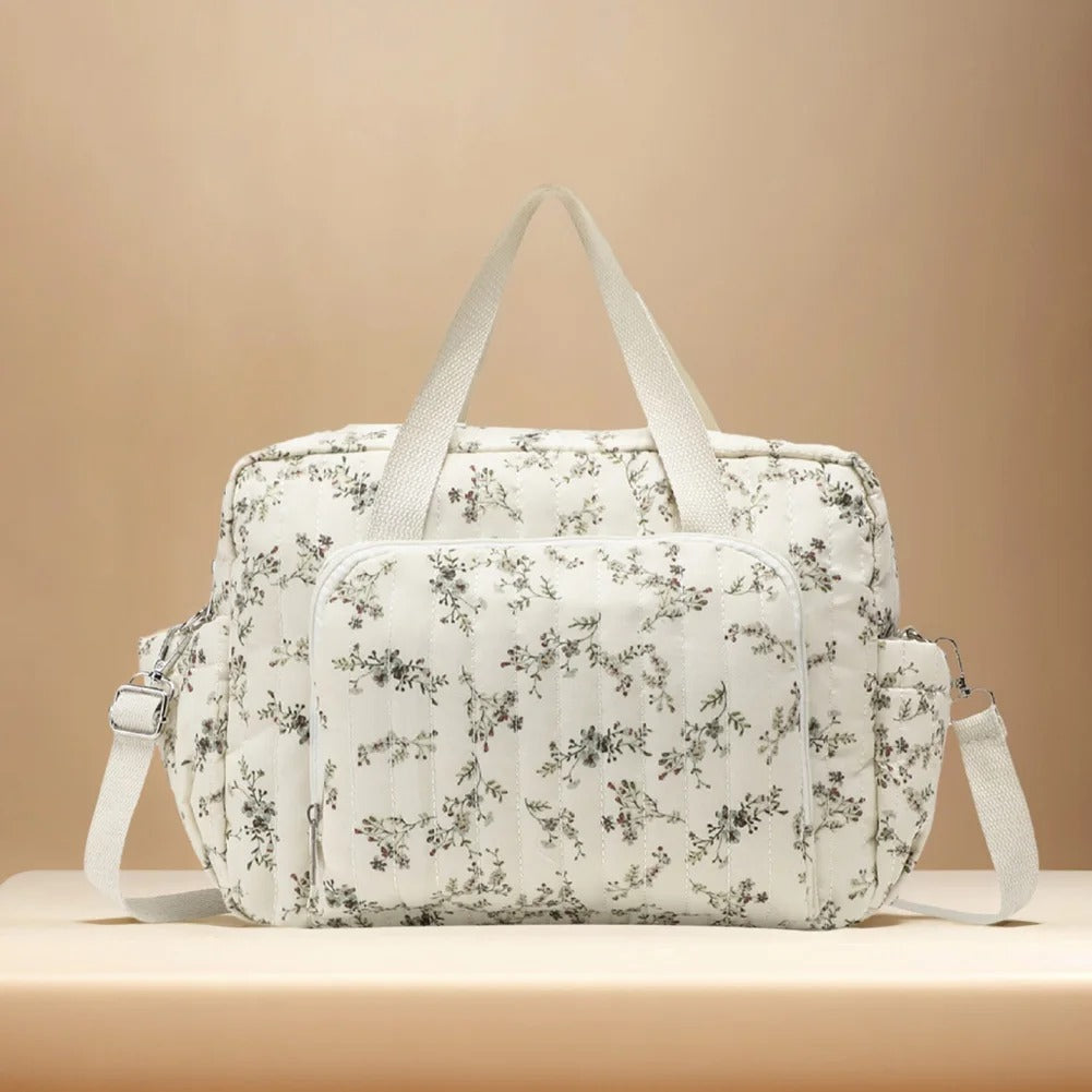 Sac à langer élégant avec motif floral blanc, pratique et spacieux pour les sorties avec bébé